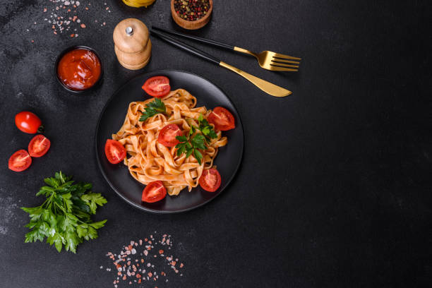 istock Tasty appetizing pasta tagliatelle spaghetti with tomato sauce and parmesan 1398147525