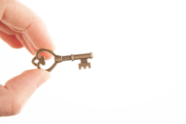 istock image of key hand white background 1398147834