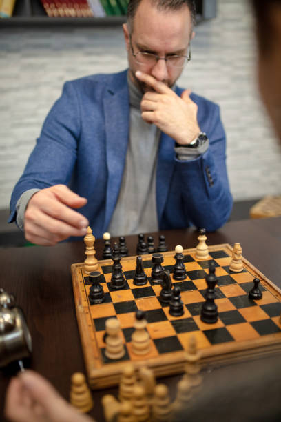 istock Couple playing chess at home 1398149197