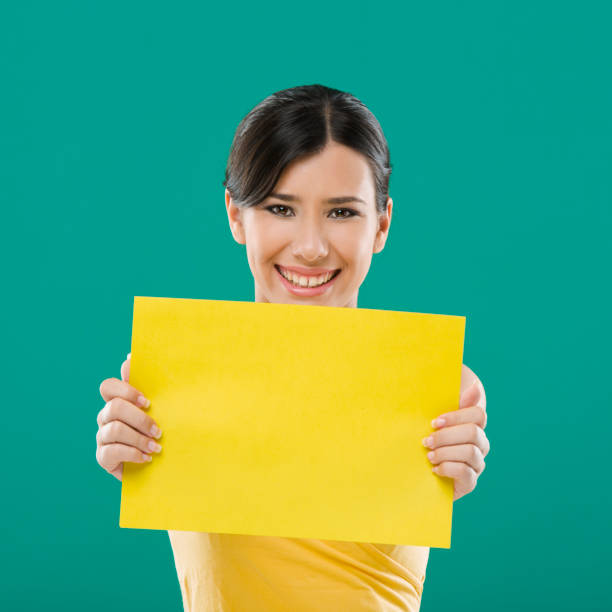 istock Holding a yellow paper 1398149550