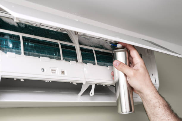 istock Male technician cleaning air conditioner indoors 1398151160