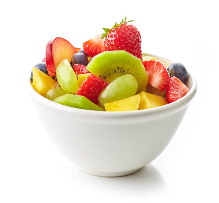 bowl of fruit salad. fresh fruit pieces foe healthy breakfast isolated on white background