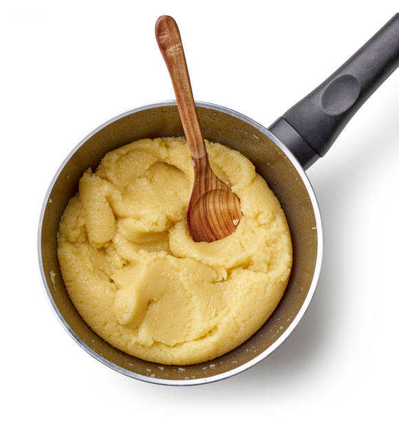 eclair dough in a pot process of making dough for eclairs or cream puffs. pot of dough isolated on white background, top view choux pastry making stock pictures, royalty-free photos & images