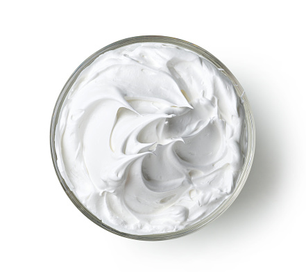bowl of whipped egg whites cream isolated on white background, top view