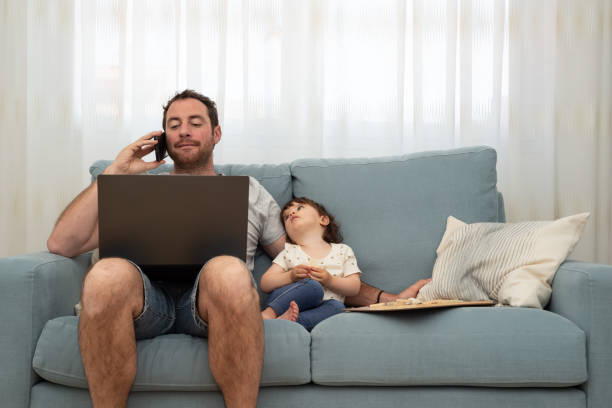 istock Father working from home while his little girl looking him bored. 1398155940