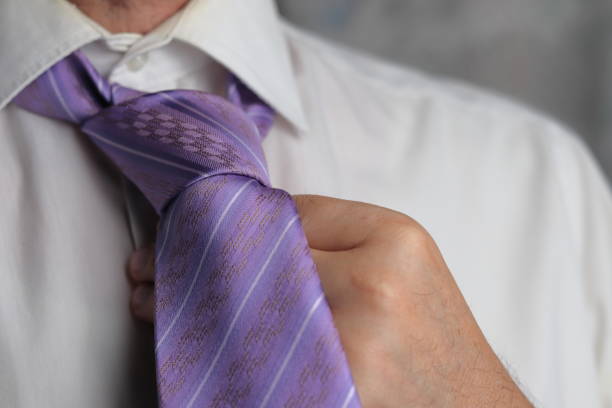 istock A man puts on a purple tie 1398157405