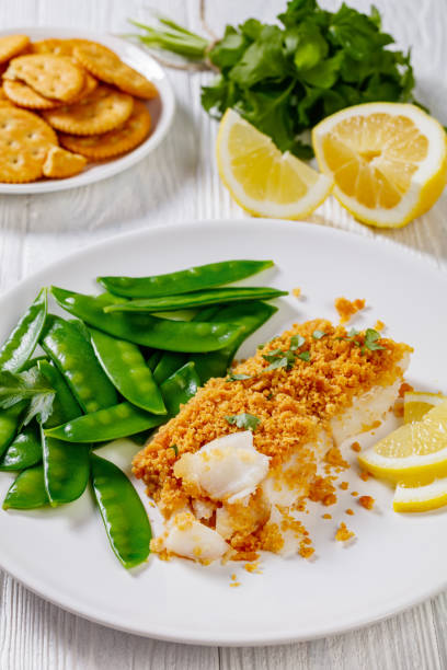 istock Baked Haddock with Crackers toppings and snow peas 1398158999