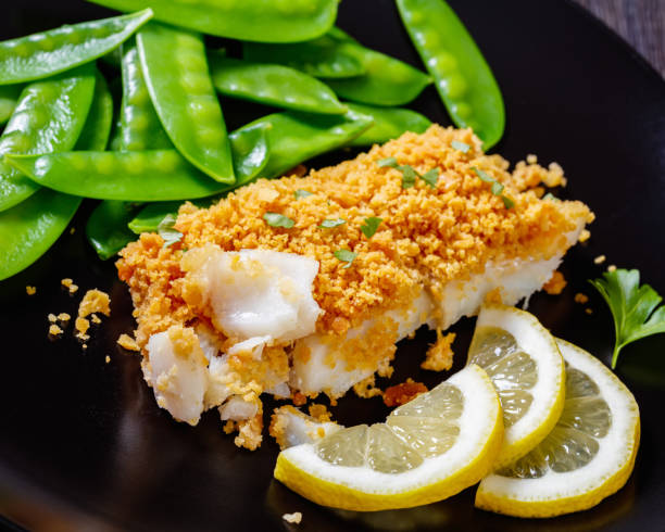 istock Baked Cod with Crackers toppings and snow peas 1398159037