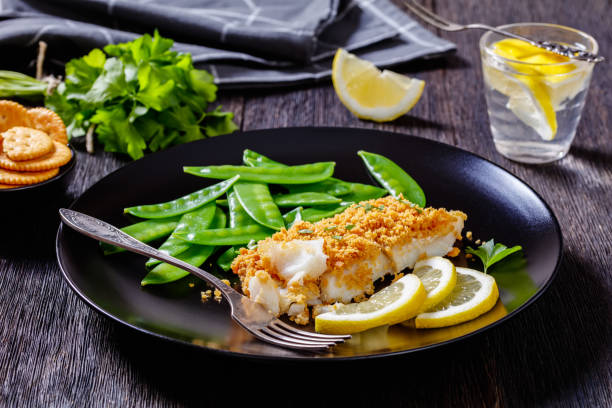 istock Baked Haddock with Crackers toppings and snow peas 1398159053