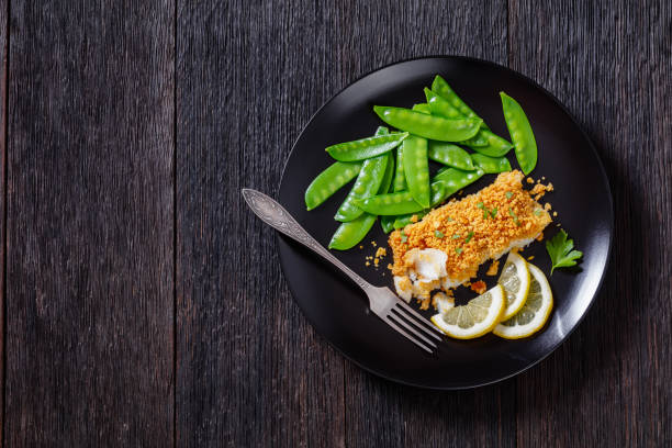 istock Baked Haddock with Crackers toppings and snow peas 1398159054