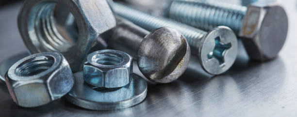 istock set of different nuts, bolts, screws, washers and drill bits,thread tap and mill cutters on steel plate background. Locksmithing deal. 1398160174