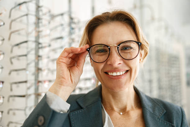 istock Satisfied client choose glasses in the ophthalmic store and look at camera 1398162669