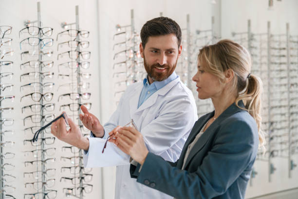 istock The ophthalmologist helps the client to choose a more suitable spectacle frame in optical store 1398162741