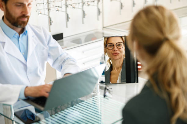 istock An ophthalmologist consults a client at his workplace in an optician's shop 1398162833