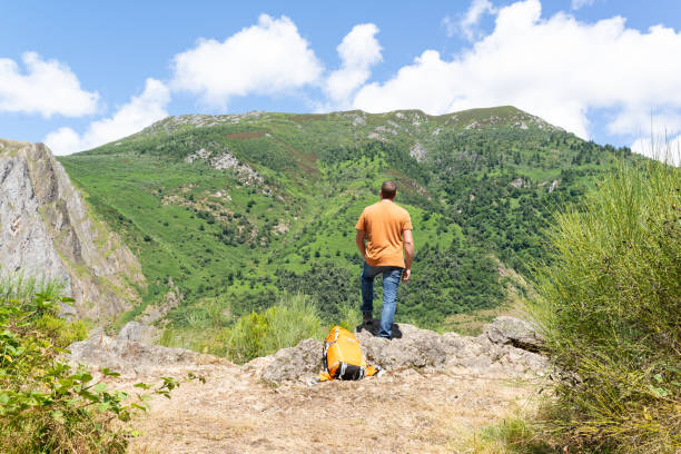 istock Back view of a man having a rest during a summer trekking day. 1398163243