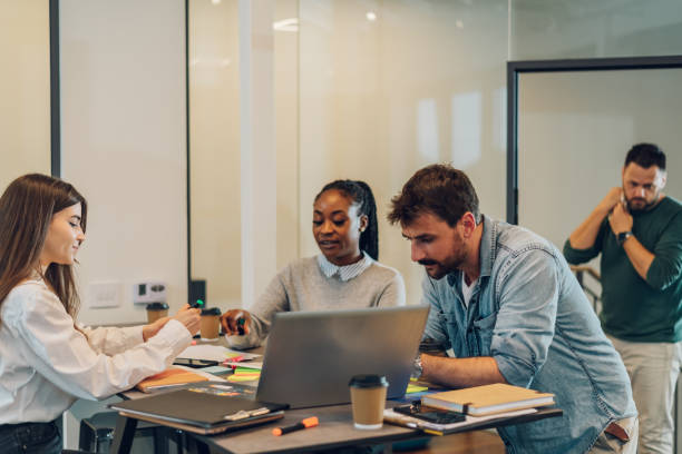 istock Three multiracial business colleagues working together in the office 1398169013