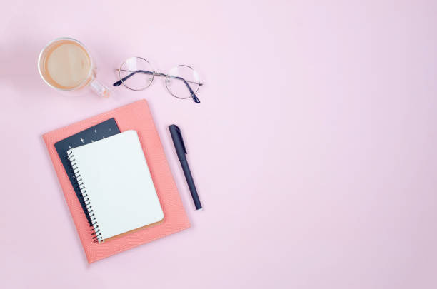 istock desktop with blank notebooks, pens, glasses and coffee 1398172216