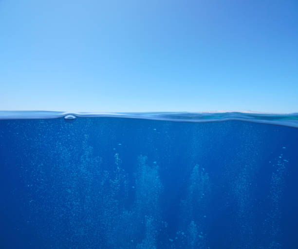 istock Blue sky with air bubbles underwater sea over under water surface 1398172947