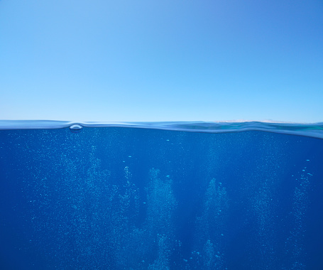 Blue sky with air bubbles underwater sea over under water surface