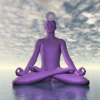 Silhouette of a man meditating with violet purple sahasrara or crown chakra symbol upon ocean in cloudy background - 3D render