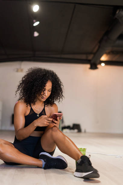 istock afro woman is seated drinking her green juice 1398175086