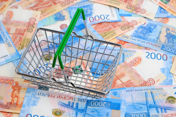 istock Shopping basket on background Russian rubles in denominations two and five thousand rubles. 1398175944