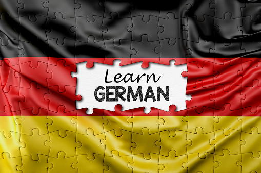German learning concept. Jigsaw puzzle pieces with Germany flag