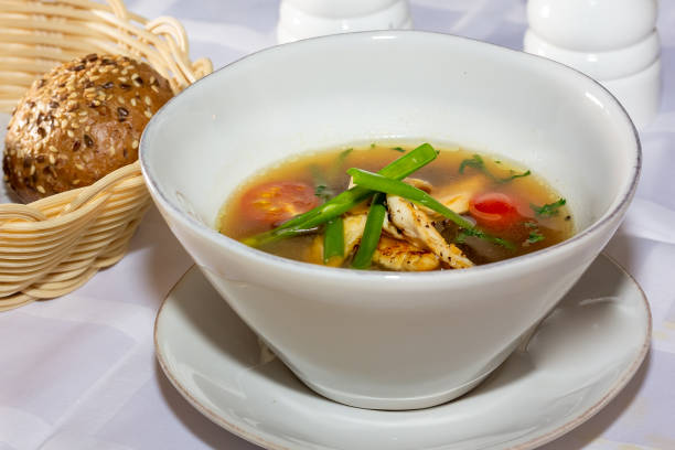 istock Chicken soup with vegetables in white bowl. Grey stone background. 1398179635