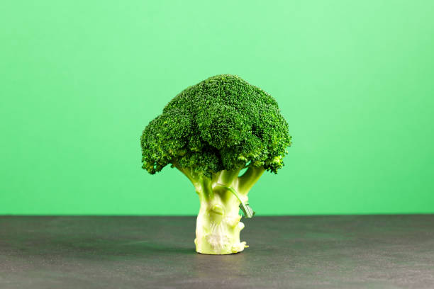 istock Large Broccoli cabbage in form of abstract tree on green background. Fresh vegetable, Organic food. Selective focus, copy space 1398181691