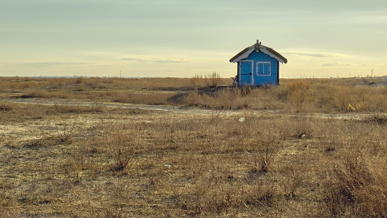 Charming blue house near the wintery sea