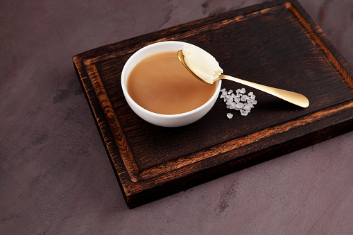 Tibetan butter tea or churned tea in white bowl. Asian drink known as \