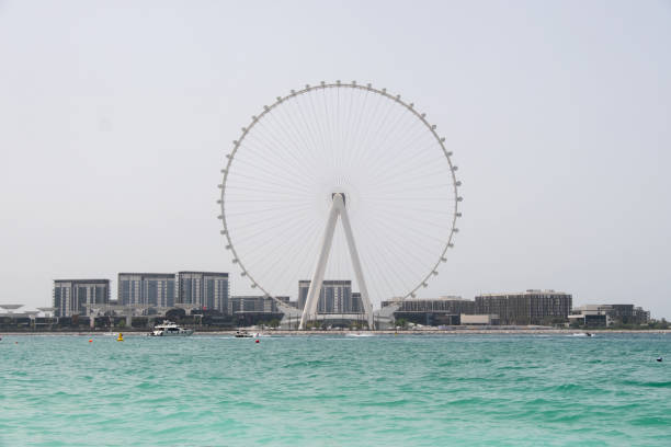 istock shot from the sea overlooking Dubai ferris wheel 1398185609