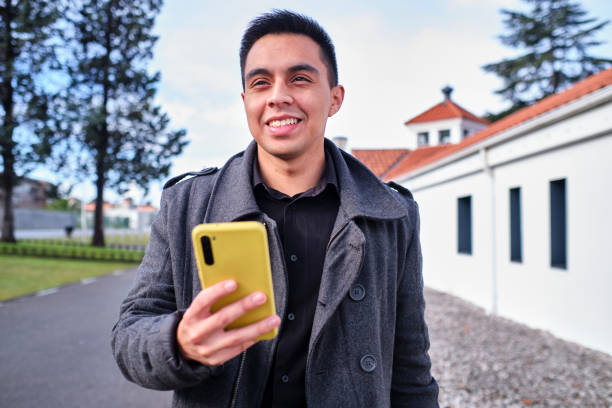 istock Young businessman holding his cell phone and smiling 1398185732