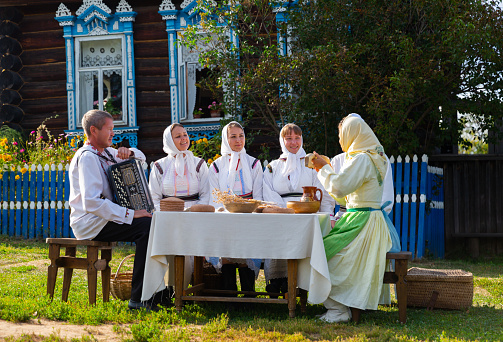KOZMODEMYANSK, RUSSIA - AUGUST 23, 2021: Group of actors in national Mari clothes showing open air theatrical performance in Ethnographic Museum