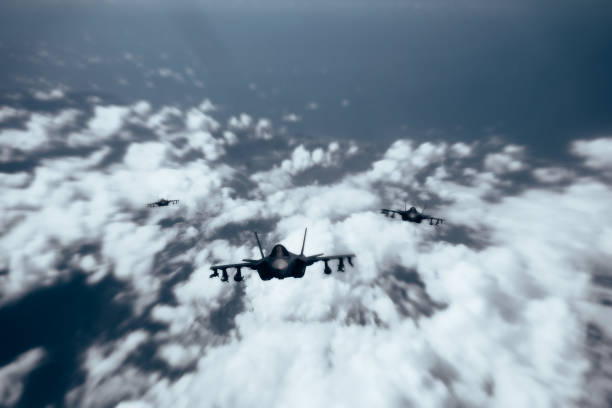 istock Jet fighters flying over the clouds. 1398187360