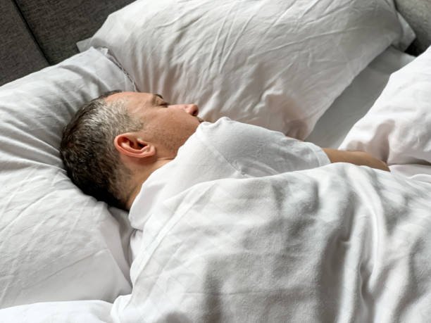 istock Middle aged man is sleeping at home 1398187438