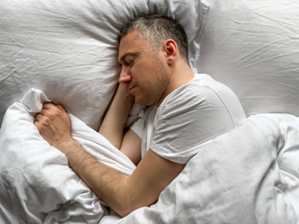 istock Middle aged man is sleeping at home 1398187439