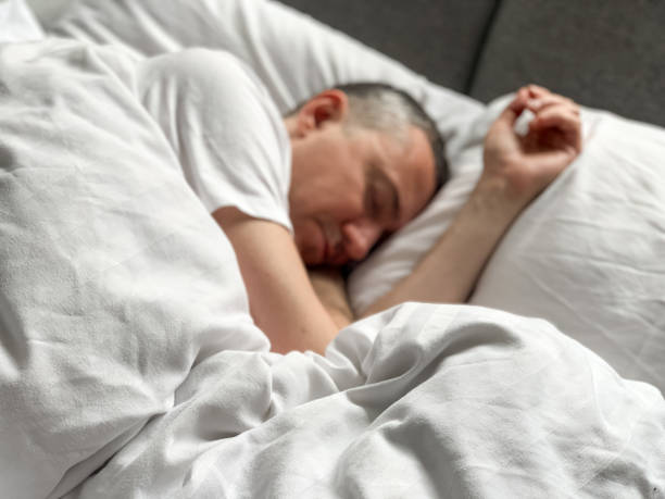 Middle aged man is sleeping at home