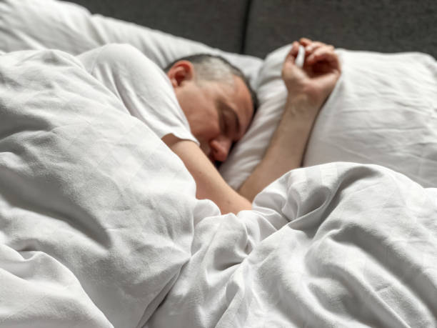 istock Middle aged man is sleeping at home 1398187488