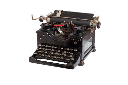 Antique black typewriter isolated on a white background