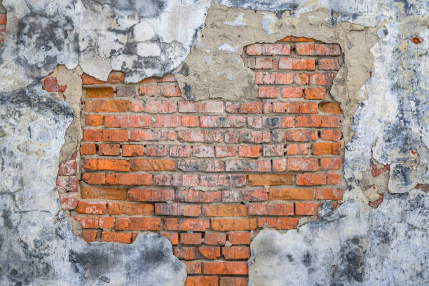 istock Grunge old red brick and plaster wall texture 1398189810
