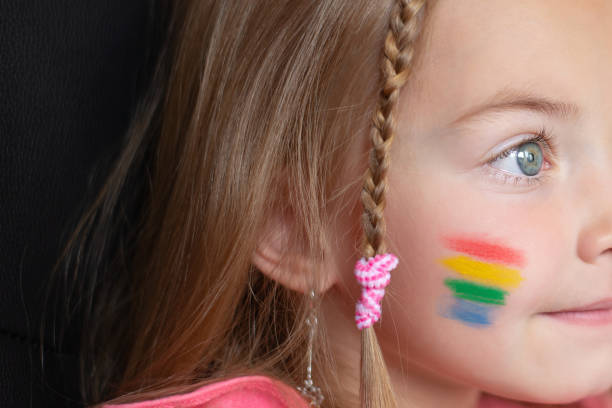 istock a little girl with a rainbow flag painted on her cheeks 1398190374