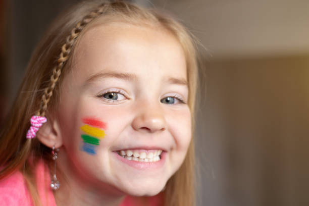 istock a little girl with a rainbow flag painted on her cheeks 1398190375