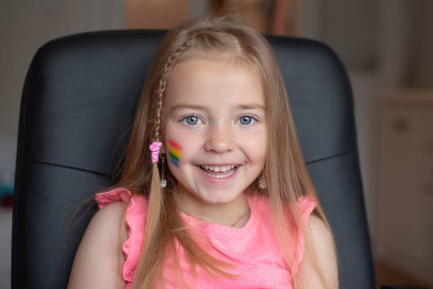 istock a little girl with a rainbow flag painted on her cheeks 1398190421