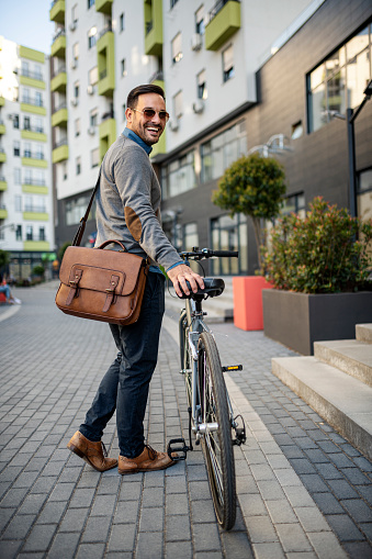 Businessman commuting to work with his bicycle