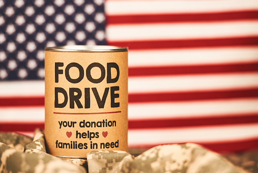 Military food drive with American flag background and military uniform. Charity and donation themes