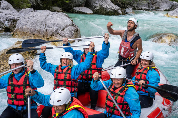 istock Smiling team members in raft, expression of positive emotions after overcoming rapids 1398204218
