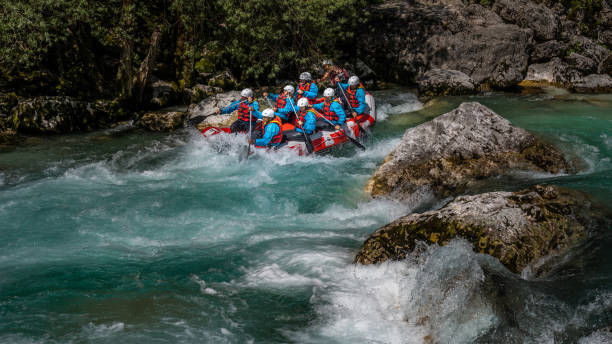 istock Adventure team riding down white water during adrenaline activity in beautiful nature 1398204235