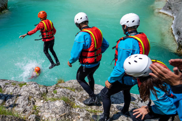 istock Group of people jumping into cold mountain water, enjoying adrenaline experience 1398204253