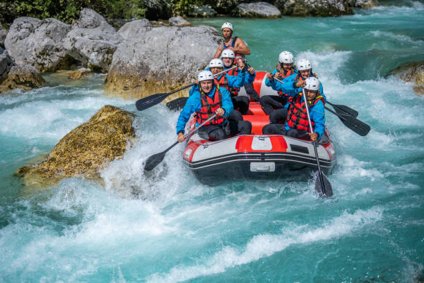 White water team adrenaline activity, paddling through rapids around large stones White water team adrenaline activity. Paddling through rapids around large stones. Rafting in wild mountain Soca river, Slovenia. primorska white sport nature stock pictures, royalty-free photos & images